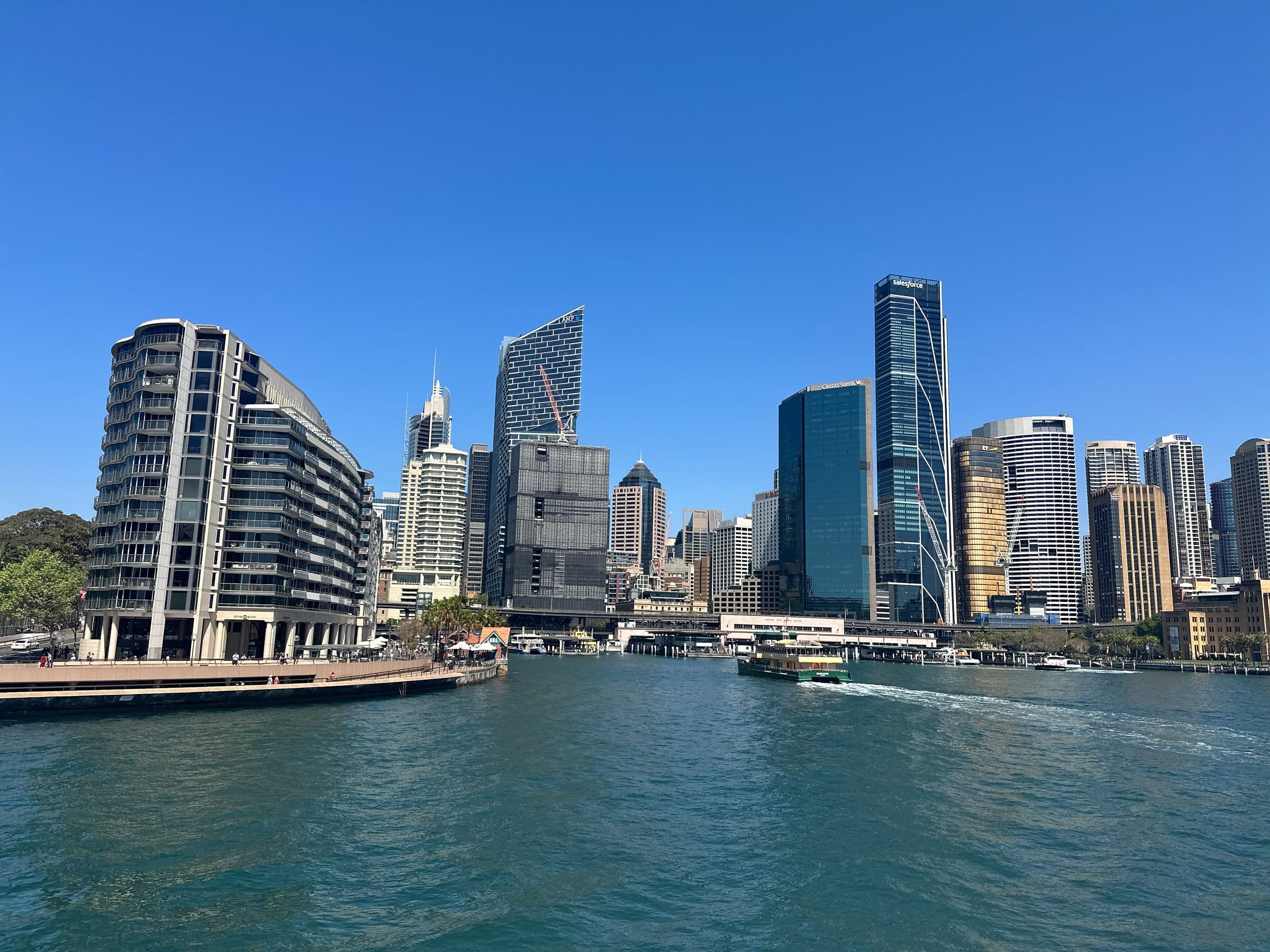 A ferry on the harbour with the city behind it
