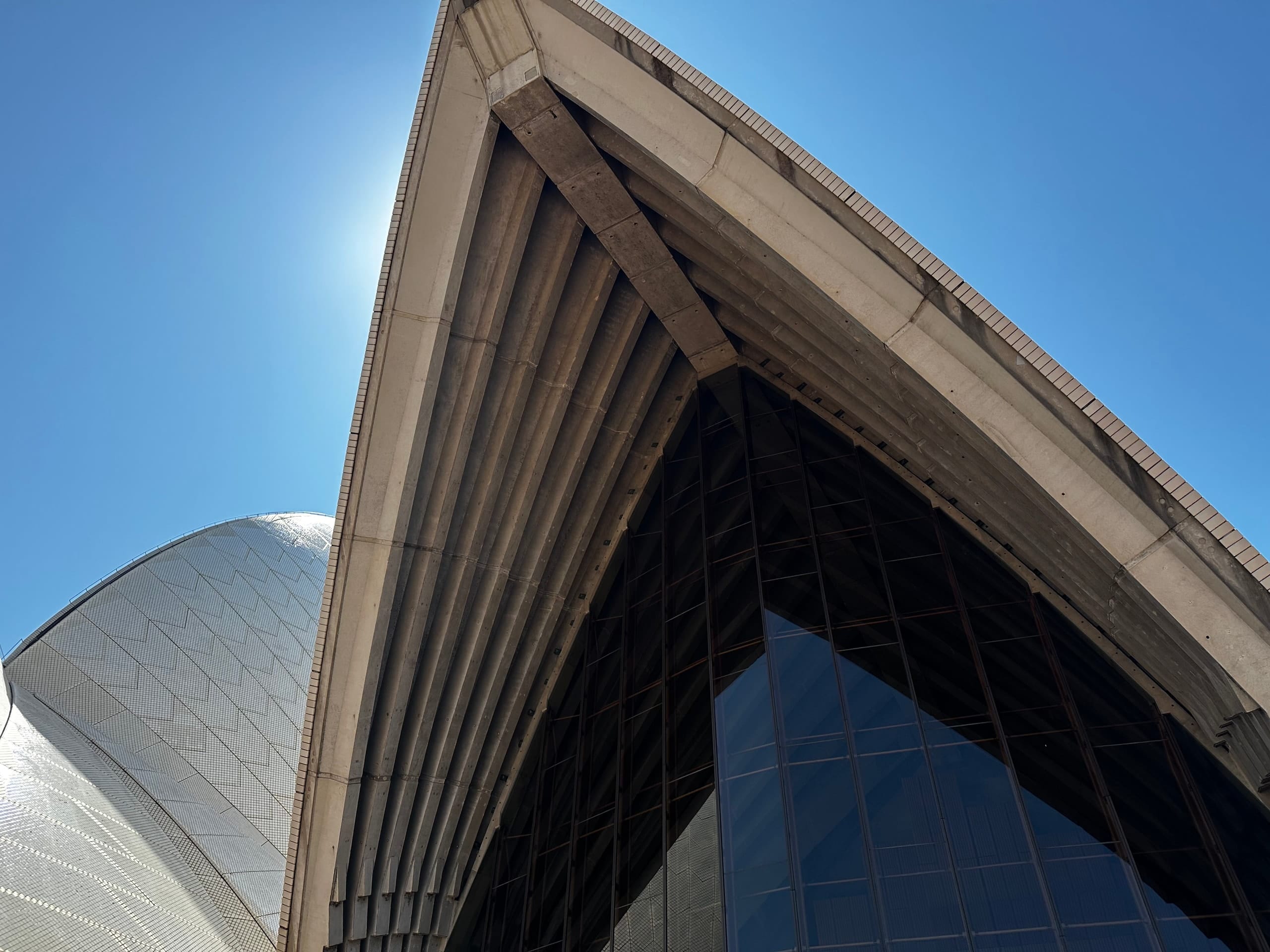 The tiled shells of the Opera House against blue sky