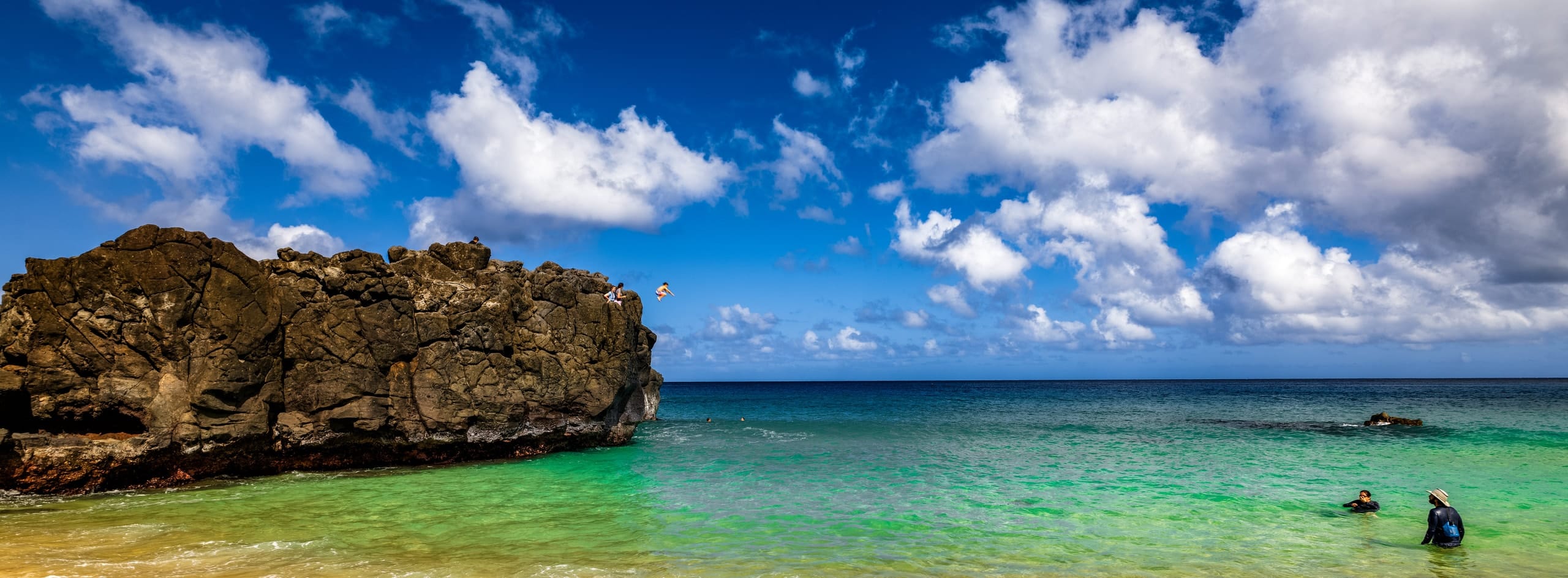 A leap from the rocks at Waimea Bay, Oahu