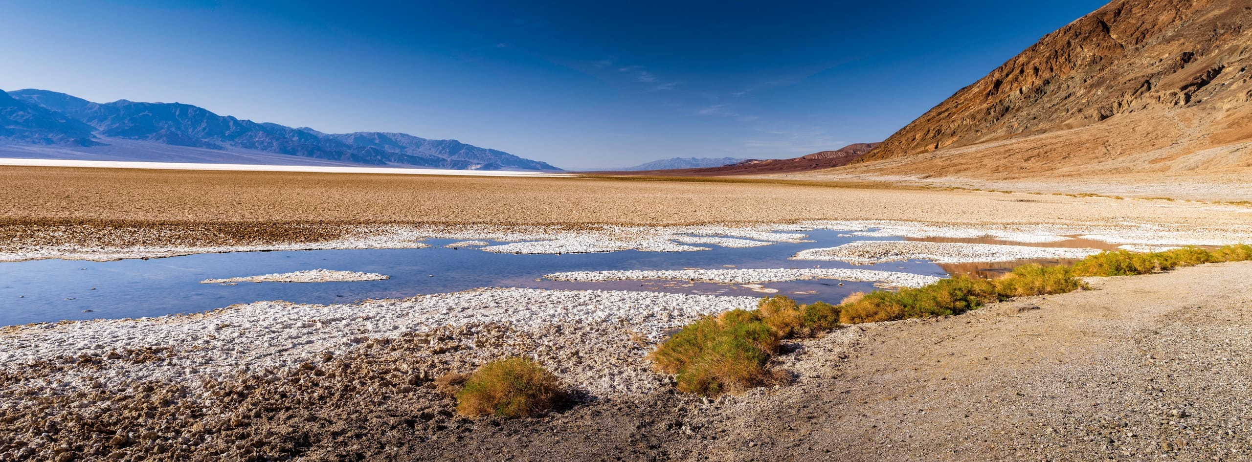 The salt flats of Badwater Basin stretching to distant mountains