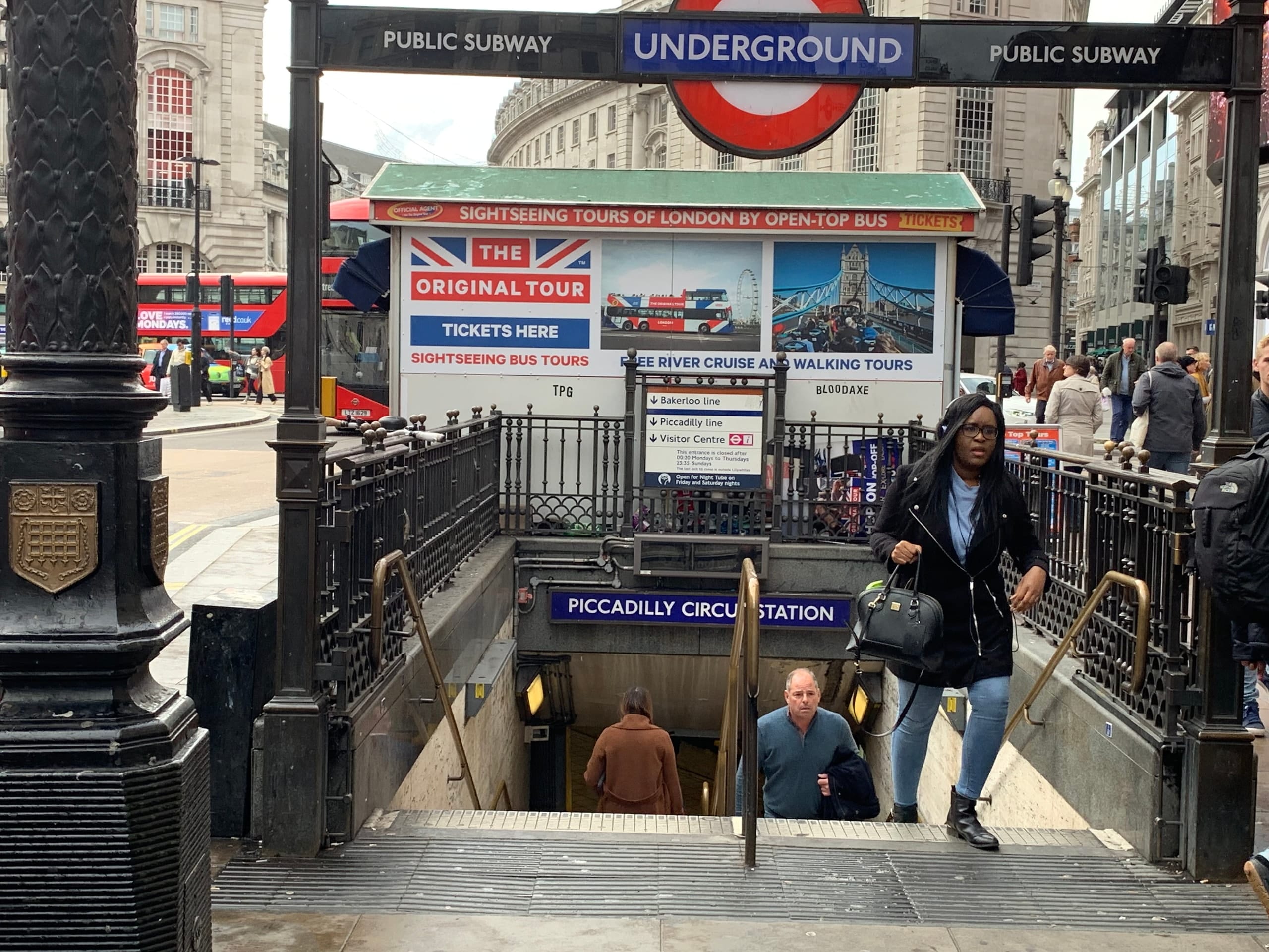 The Piccadilly Circus Underground entrance and a red bus