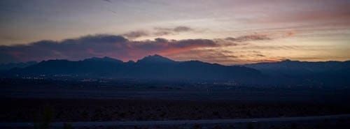 A long mountain skyline under broken cloud