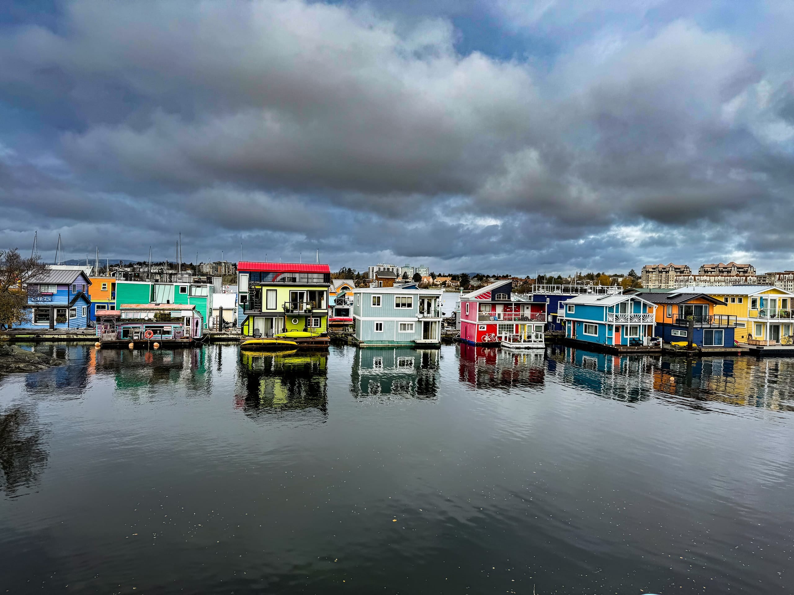 Coloured houseboats and their reflections in Victoria harbour
